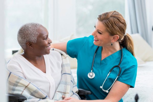Nurse and resident smiling at each other