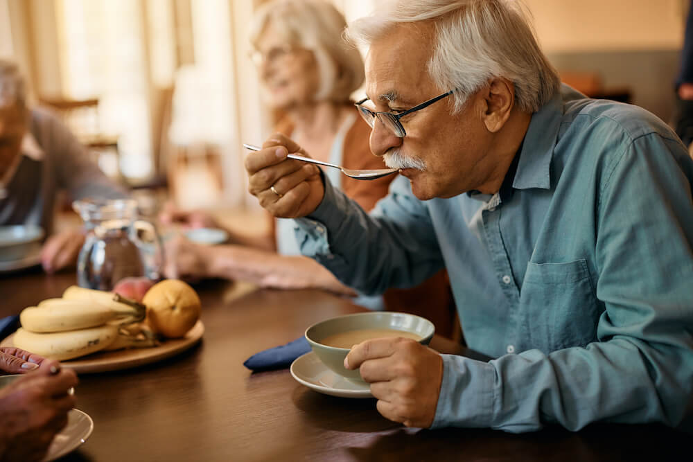 senior man eating lunch at nursing home