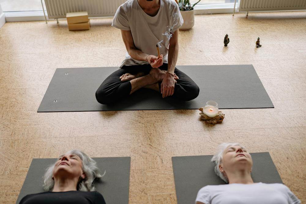 A group of women practicing yoga in a room.